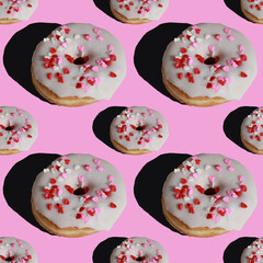 seamless pattern of donuts with sugar glaze on pink background