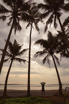 Man admiring ocean coastline, Bali, Indonesia