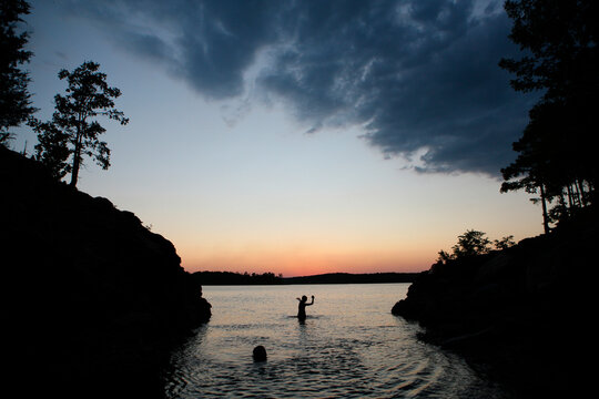 Boy throws stone in Lake Ouachita in Arkansas