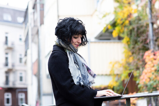 Young Woman Working With Laptop Outside