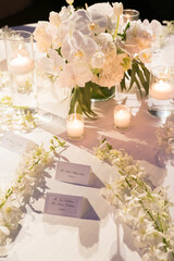 Wedding Invitation card mockup in the white table with flowers