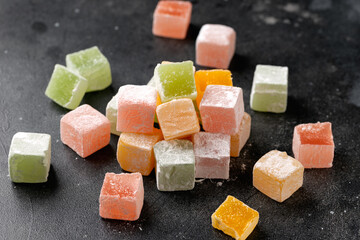 Turkish delights on dark background. Sweets food.