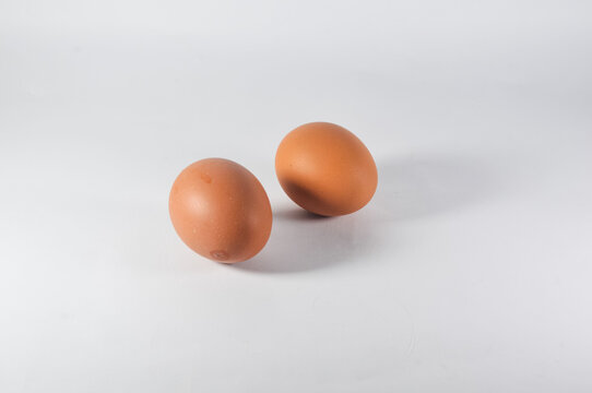 two raw chicken eggs isolated on white backgrond
