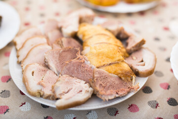 set of cold cuts of cooked chicken and pork meat on plate