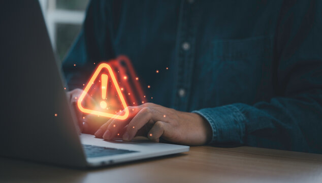 Businessman Using Computer Laptop With Red Triangle Caution Warning Sign For Notification Error And Maintenance Support Concept.