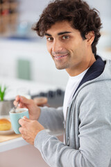 healthy adult man having breakfast in apartment