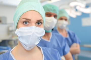 young woman doctor or nurse in cap and face mask