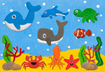 Naklejka na ściany i meble happy sea life animal made from plasticine on sand and sea under water background