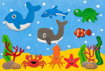 Wall murals Sea life happy sea life animal made from plasticine on sand and sea under water background