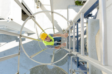 high angle view of man climbing ladder in curcular framework