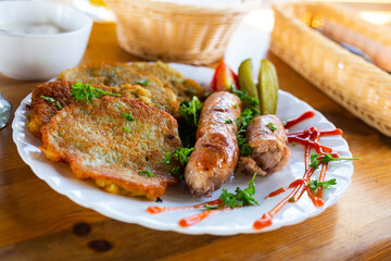 belarusian pancakes with sausages in a restaurant