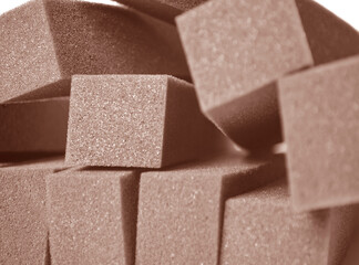 stacked blocks of brown sponge foam