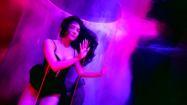 sexy young woman underwater, beautiful fashion model in water of pool with color illumination