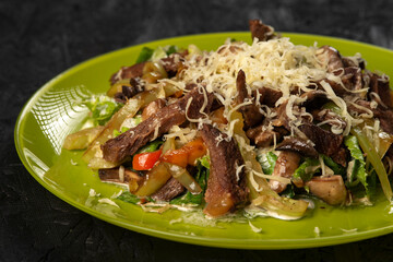 beef salad with vegetables on black background