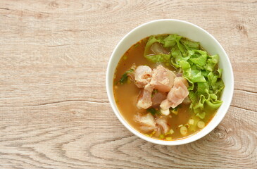 boiled slice braised beef tendon in spicy and sour tom yum soup on bowl