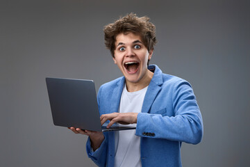 caucasian man with laptop on gray background