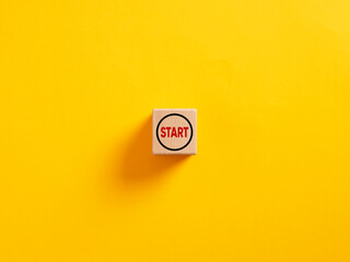 The word start on a wooden cube. To make a new start in life, business, education or career concept. Start button. - obrazy, fototapety, plakaty