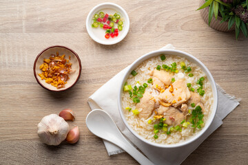 Chicken Porridge,rice soup with sliced chicken breast in white bowl.Asian breakfast style.Top view