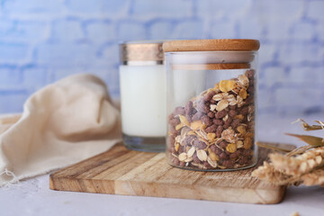 Home Made Musli in a in a jar and glass of milk on table 