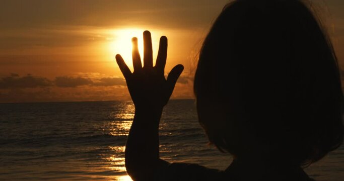 little boy kid catching sun glare with fingers hand, child silhouette enjoy family trip to ocean childhood dreams and memories concept, happy kid at sunset,human hand, child dream, tranquil scene