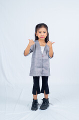 Kid model girl posing in studio background. 5 years old asian kid hand gesturing in style. 