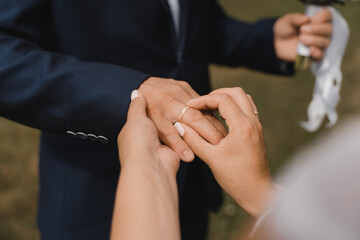 Obraz na płótnie Canvas ceremony of exchanging wedding rings close-up