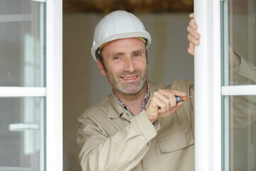 handsome builder at camera and smiling