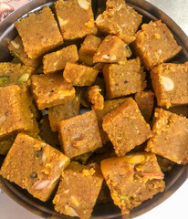 Moong dal or besan Barfi - an Indian dessert. A freshly prepared sweet dish packed with dry fruits...
