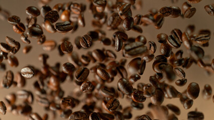 Freeze motion shot of rotating coffee beans, brown gradient background