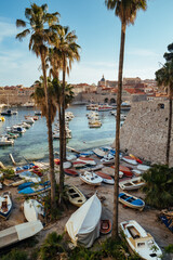 Fototapeta na wymiar Boats anchored in Dubrovnik old town, in Croatia, on a tranquil sunny day