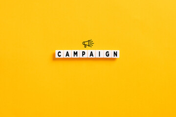 Business marketing campaign or sale announcement concept. White letter blocks on yellow background with the word campaign and a megaphone symbol.