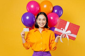 Happy fun smiling young woman wearing casual clothes celebrating hold in hand mock up of credit...
