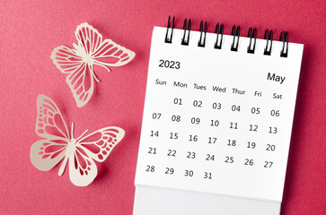 A May 2023 desk calendar for the organizer to plan and reminder with paer butterfly on red background.