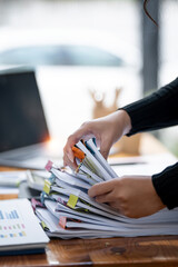 Business Documents concept,  woman hands working on Stacks paper files for checking document...