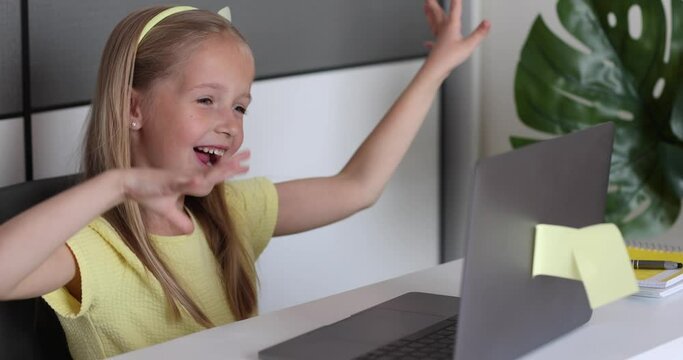 Caucasian little girl school pupil studying online from home, watching web class lesson or listening tutor by video call elearning during coronavirus covid-19 pandemic self isolation. Slow motion
