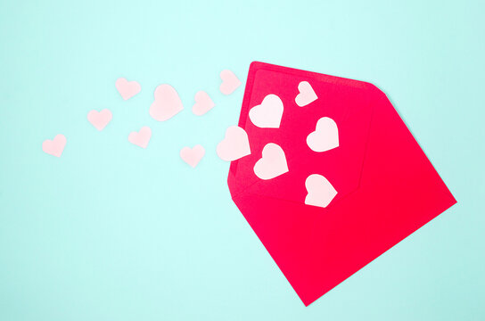 Envelope and various pink hearts on blue background - Powered by Adobe
