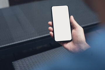 Mobile phone mockup for advertising. Mock up image of man hand holding and using smartphone with blank screen for mobile app design or text advertisement