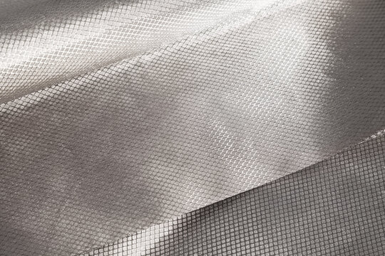 Protective RFID, EMI, cell signal blocking Faraday fabric. Shielding conductive cloth with metal grid that blocks wireless signals, EMF radiation