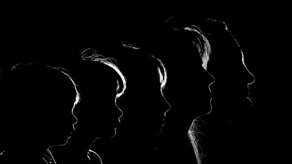 Halo outline glowing light behind family portraits in the dark