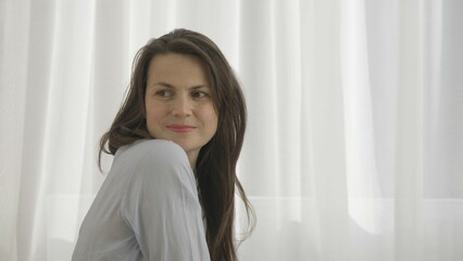 Young lady enjoys new mother role sorting newborn baby clothes