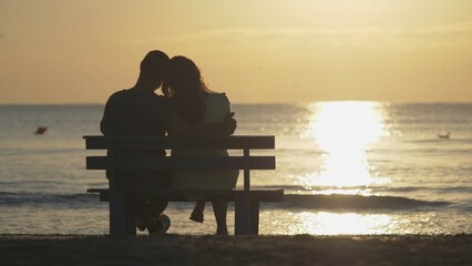 Couple of lover sit on bench at beach, sunrise, beginning hope, dream