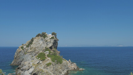 Isolated cliff above sea with its Agios Ioannis church on top