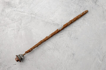 Severe wear of the magnesium anode. Rod to protect the boiler against rust on a gray concrete...