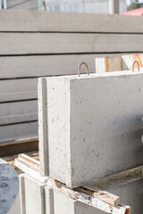 Close-up of a reinforced concrete foundation block in a factory warehouse.
