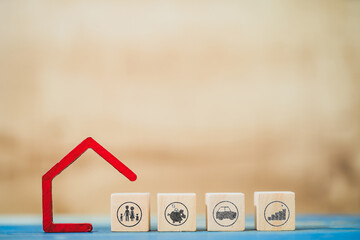 Home model and wooden block with the family,piggy bank,car and bar graph with investment put on the desk in the office, Saving money for planning concept.