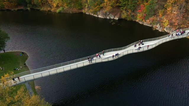 Recreation area near Grodno castle in Zagorze, Poland. Beaituful autumn landscape with mountains covered with forest, river and bridge for people over it
