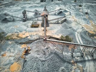 Stone crushing machine system at open pit mining quarry. Aerial drone shot