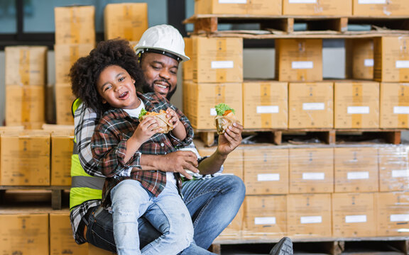 Single African father worker, hug his son, holding cup coffee, burger, having lunch together, happy smiling, taking break, work in factory for delivery. Family, Industry Business Concept.