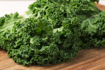 Curly Kale on a wooden cutting board. Healthy eating concept. Superfoods. Organic food.