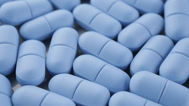 Blue pills close up, rotation. Pharmaceutical Industry. The medicine concept